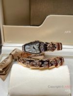 High Quality Replica BVLGARI Serpentine-Spiga K Gold With Zircon-Inlaid Strap Natural Mother-of-Pearl With Black Enamel Face Dial 316 Stainless Steel Case Watch